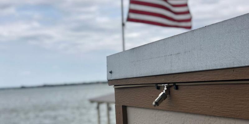 misting system near water with American flag in background